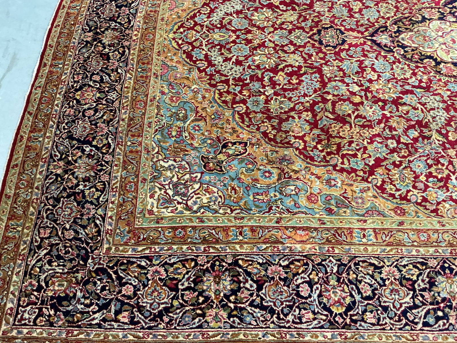 The same section after cleaning, with the pale blue scrollwork and pink florals separated and legible